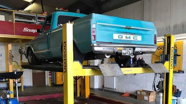 Classic GMC pickup truck on a vehicle lift at MVM Garage Bridlington