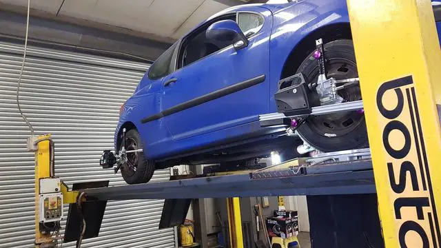 Blue car on a wheel alignment lift at MVM Garage Bridlington