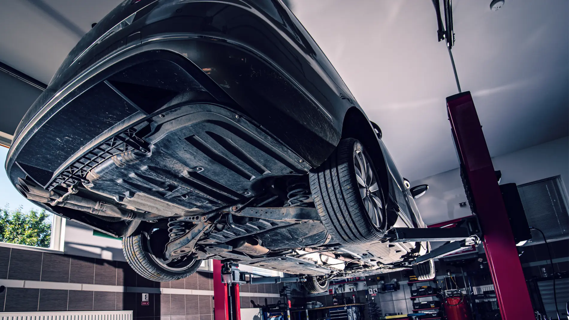 Car raised on a lift showing the underside in the MVM Garage workshop, Bridlington