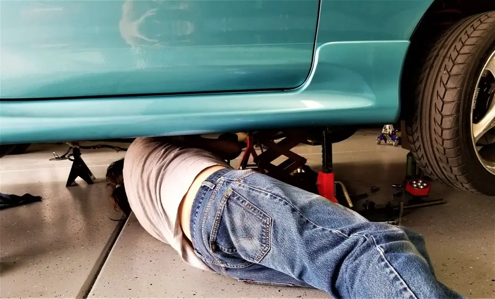 Mechanic working underneath a car during an MOT inspection at MVM Garage Bridlington