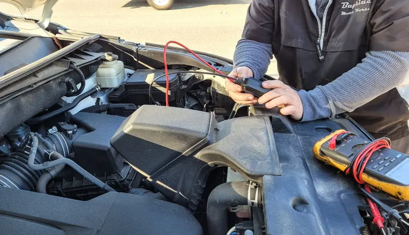 Mechanic checking a car battery and engine at MVM Garage Bridlington